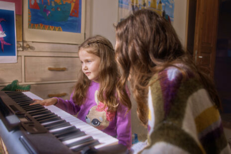 Child enjoying learning piano on a tablet with Simply Piano, one of the best piano applications for kids